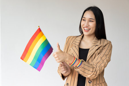 Non-binary LGBT person showing good accepting thumb up hand sign for LGBT awareness pride monthの写真素材