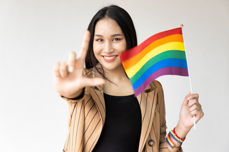 Non-binary LGBT person showing L hand sign for LGBT awareness pride monthの写真素材