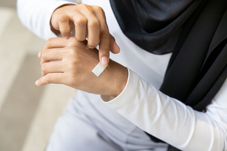 Wounded hand of woman, first aid treatment covering with clean bandage, closeup shotの写真素材