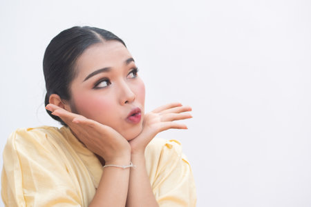 excited young woman looking up to blank spaceの写真素材