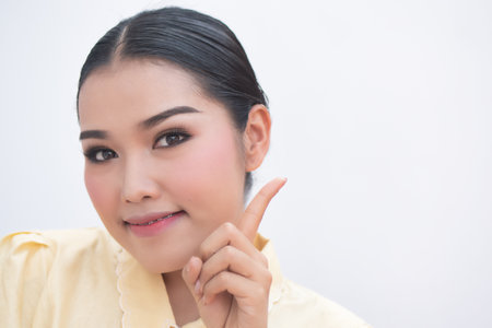 asian plus size woman pointing up confident winning one finger sign for number one or first point leader conceptの写真素材