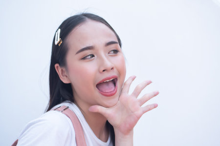Confident young asian woman pointing up five fingers hand signの写真素材