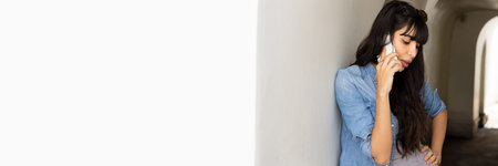 South latin American woman talking on smartphone, header banner crop