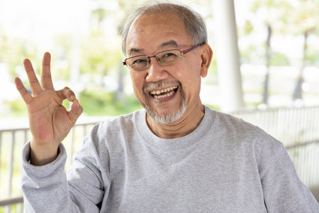 Happy smiling old senior man showing accepting ok hand gestureの写真素材