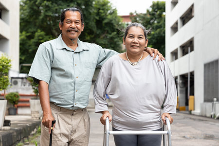 Happy smiling senior husband and wife, family life of aging couple with supporting couple, good aging society conceptの写真素材