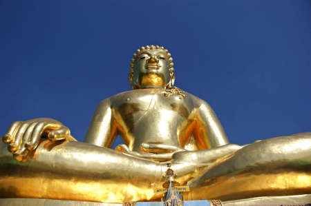 Golden Buddha in the attitude of subduing Mara manner located at golden triangle の写真素材