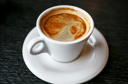 Coffee cup and beans on a black background.の写真素材