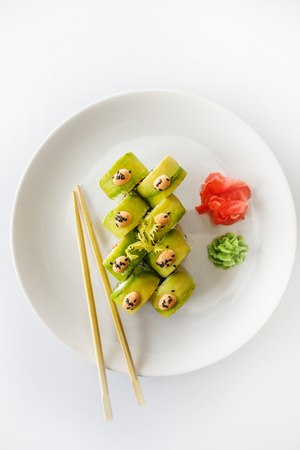 Japanese  seafood  sushi , roll and chopstick on a white plate with ginger and wasabiの写真素材