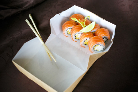 set of sushi, sushi set, Japanese sushi, salad, ginger, wasabi, in a box, on a vinous backgroundの写真素材