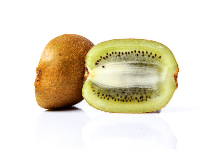 Slice of fresh kiwi fruit isolated on white background with reflectionの写真素材