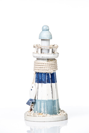 wooden lighthouse miniature isolated on whiteの写真素材
