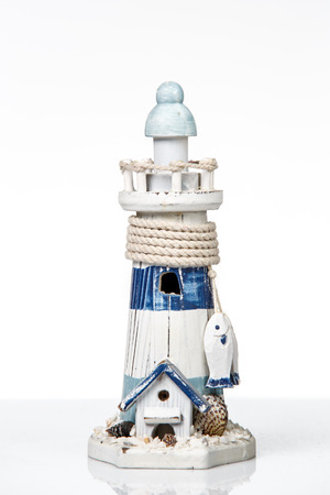 wooden lighthouse miniature isolated on whiteの写真素材