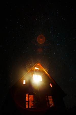house under the sky of night starsの写真素材