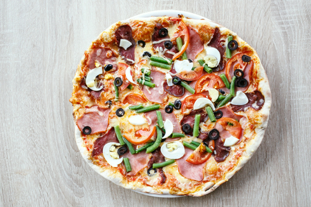 Top view of Delicious Fresh Pizza with beans, cheese, ham and eggsの写真素材