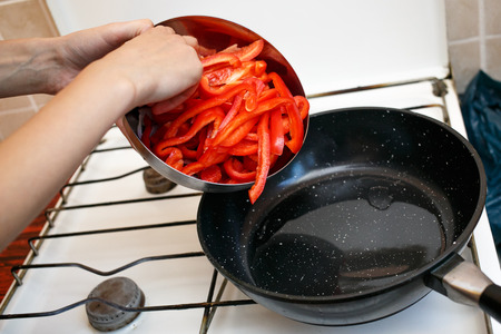 Fresh vegetables, peppers and onions in a frying pan, cooking food at home soviet union kitchenの写真素材