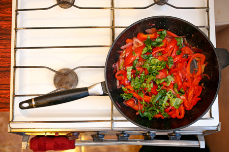 Fresh vegetables, peppers and onions in a frying pan, cooking food at home soviet union kitchenの写真素材