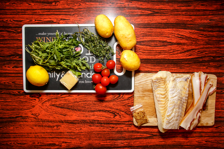 Fresh farmers market fruit and vegetable with fish fillet on red tableの写真素材