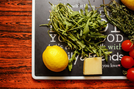 Fresh farmers market fruit and vegetable with cheese on red tableの写真素材
