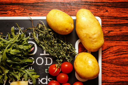 Fresh farmers market fruit and vegetable with cheese on red tableの写真素材