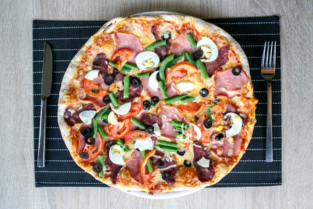 Top view of Delicious Fresh Pizza with beans, cheese, ham and eggsの写真素材