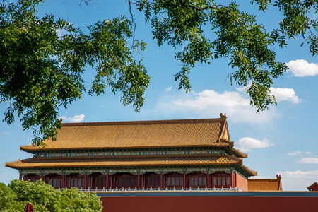 Traditional Chinese architectural roof, with animals. Immortal and beasts on the roof slope. Authentic China city, The yellow roof tiles with dragonの写真素材