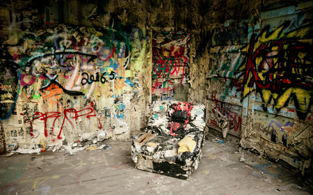 armchair in a destroyed interior of a roomの写真素材