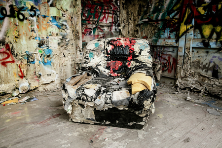 armchair in a destroyed interior of a roomの写真素材