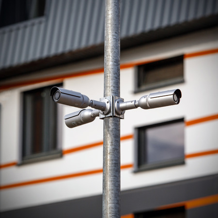 surveillance camera on a pole in the courtyardの写真素材