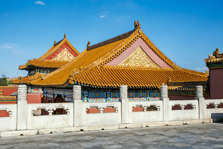 Traditional Chinese architectural roof, with animals. Immortal and beasts on the roof slope. Authentic China city, The yellow roof tiles with dragonの写真素材
