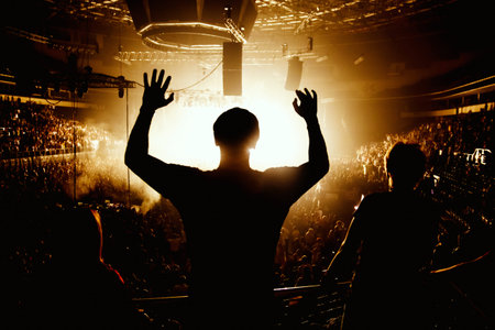 Black silhouette of happy man on rock concert