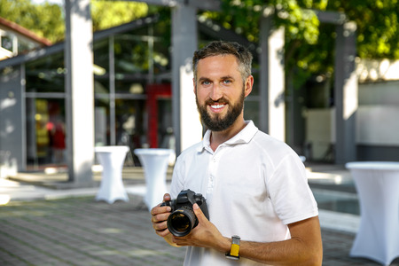 event wedding photographer with camera in hands, Beard and smileの写真素材