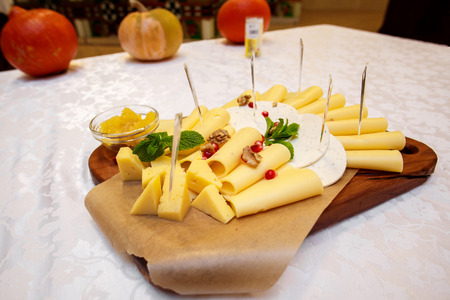 Cheese plate with variety of appetizers on table on event cateringの写真素材