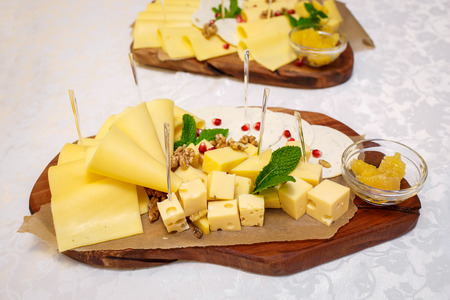 Cheese plate with variety of appetizers on table on event cateringの写真素材