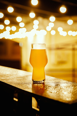 A glass of kraft beer on the background of lanterns, Flashlightsの写真素材