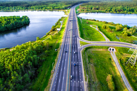 Green forest and asphalt road from droneの写真素材