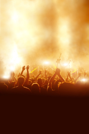 silhouettes of rock concert crowd in front of bright stage lights, With space for textの写真素材