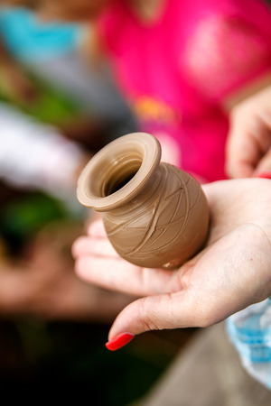 Hands working on pottery wheel, making a vaseの写真素材