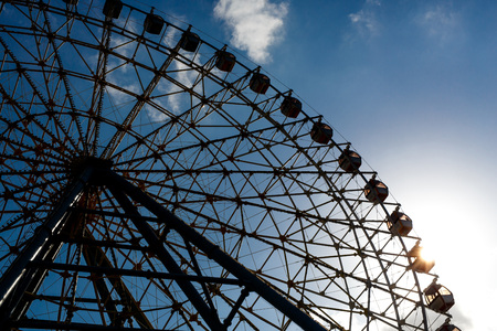 Part of ferris wheel silhouette during sunset.の写真素材