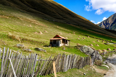 Wooden house at the bottom of the mountain.の写真素材