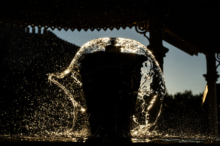 Water splashing on a big cupの写真素材