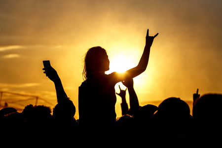 Girl cheering at outdoor music, rock festivalの写真素材