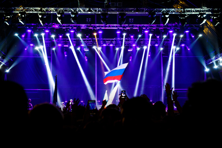 Russian flag at the concert, opposite the light from the stageの写真素材