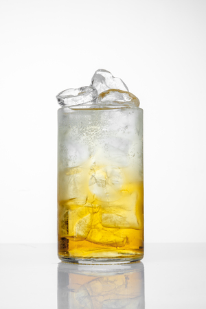 Glass with juice and ice on the white background.の写真素材