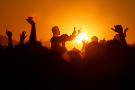 Silhouette of a Man Taking a Photograph with his SmartPhone, outdoor party
