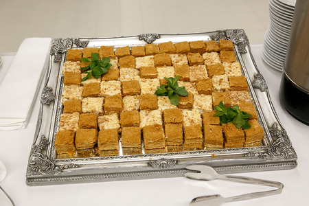 a lot of pieces of fresh honey cakes, on a iron trayの写真素材