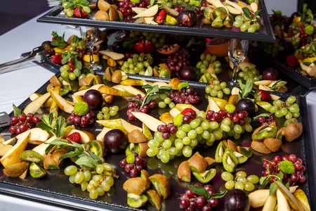 Slices of fruits on banquet table, event cateringの写真素材