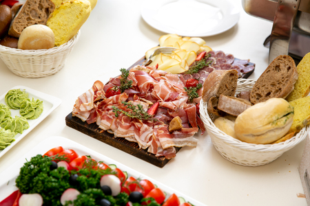 A lot of different snacks on event catering, meat-cuttingの写真素材