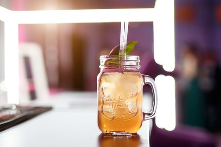 Glass bank of lemonade with sliced citrus fruits on a bar table. Summer partyの写真素材