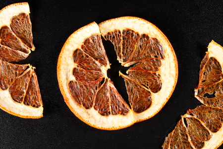 Dried grapefruit on black background, top viewの写真素材