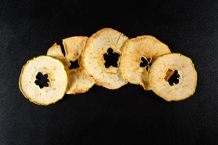 Dried apple, five slices on black background